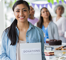 Woman collecting donations at a bake sale 